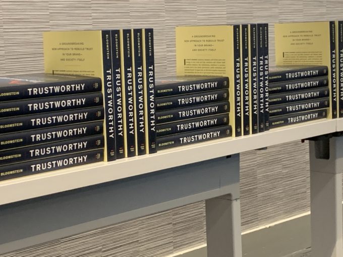 The book "Trustworthy" stacked vertically in one row and then horizontally in the next row with the pattern repeating.